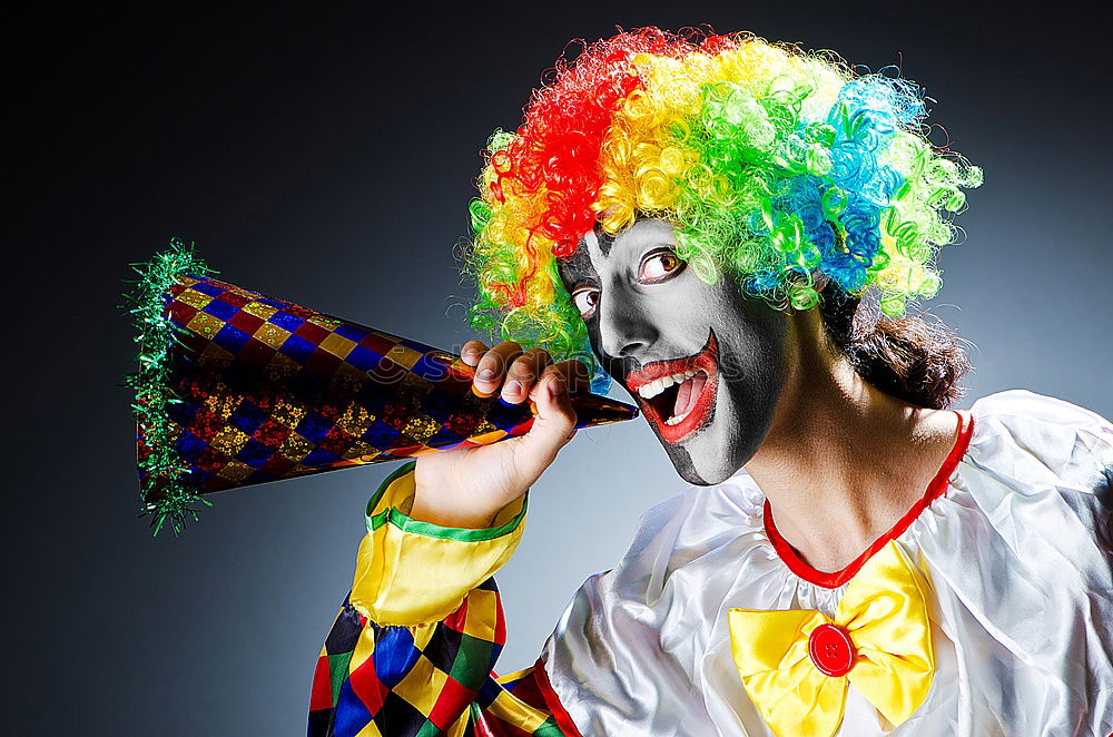 Similar – boy dressed as a clown on black background