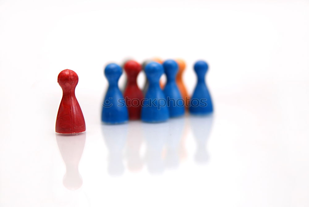 Similar – Three game pieces in German colours stand in front of a large group of game pieces in black, red, gold