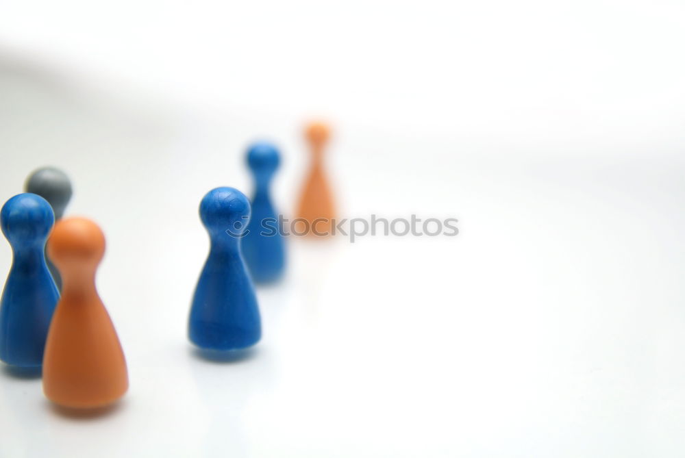 Similar – Three game pieces in German colours stand in front of a large group of game pieces in black, red, gold