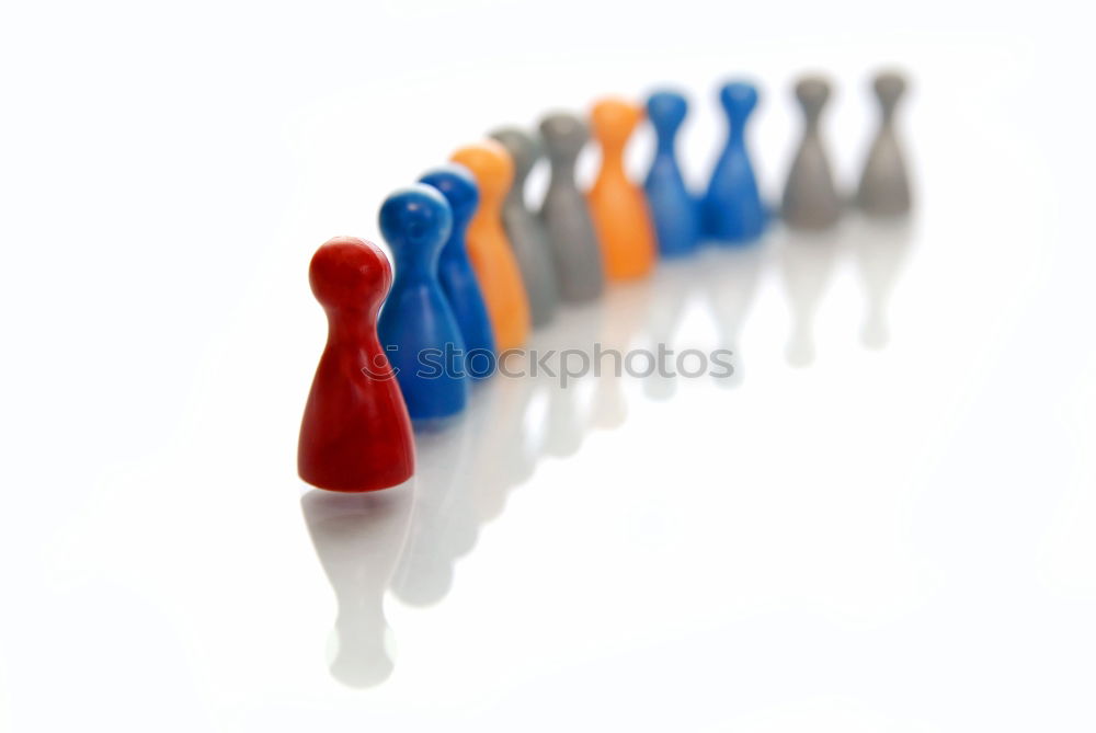 Similar – Three game pieces in German colours stand in front of a large group of game pieces in black, red, gold