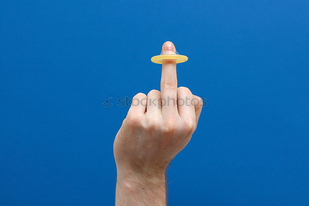 Laughing finger girl with mini knitted cap and red cheeks