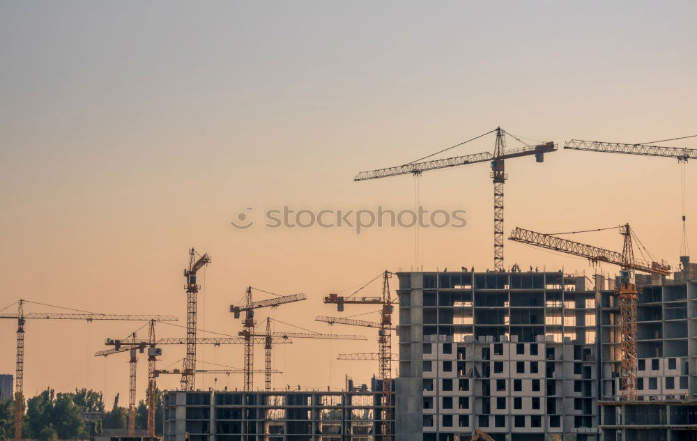 Similar – Construction site with building cranes