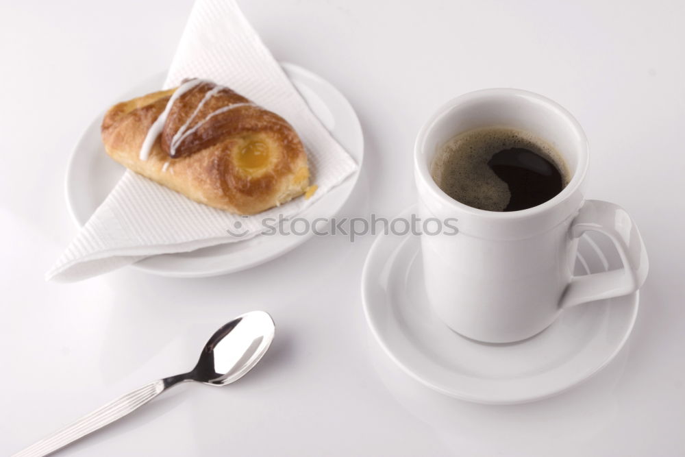 Similar – Image, Stock Photo Overhead view of a cup of black espresso coffee and a freshly baked croissant for breakfast. High angle close up