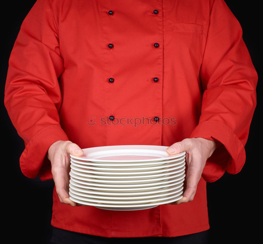 Similar – cook in red uniform holding an empty black frying pan