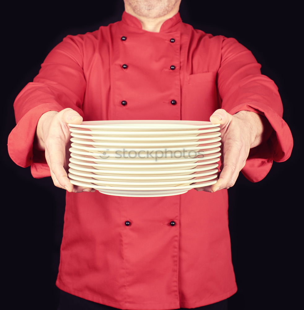 Similar – cook in red uniform holding an empty black frying pan