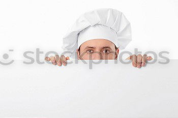 Similar – Young man looks curiously over a barrier