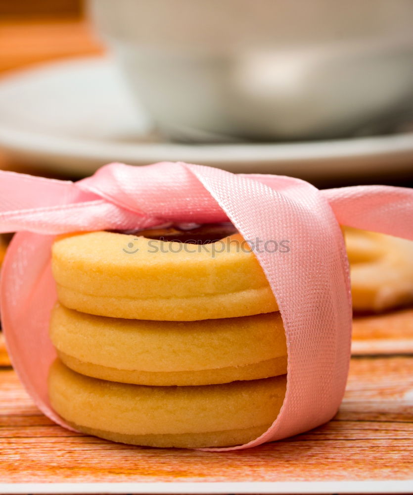 Similar – Image, Stock Photo A few gingerbread cookies wrapped in red ribbon on wooden table