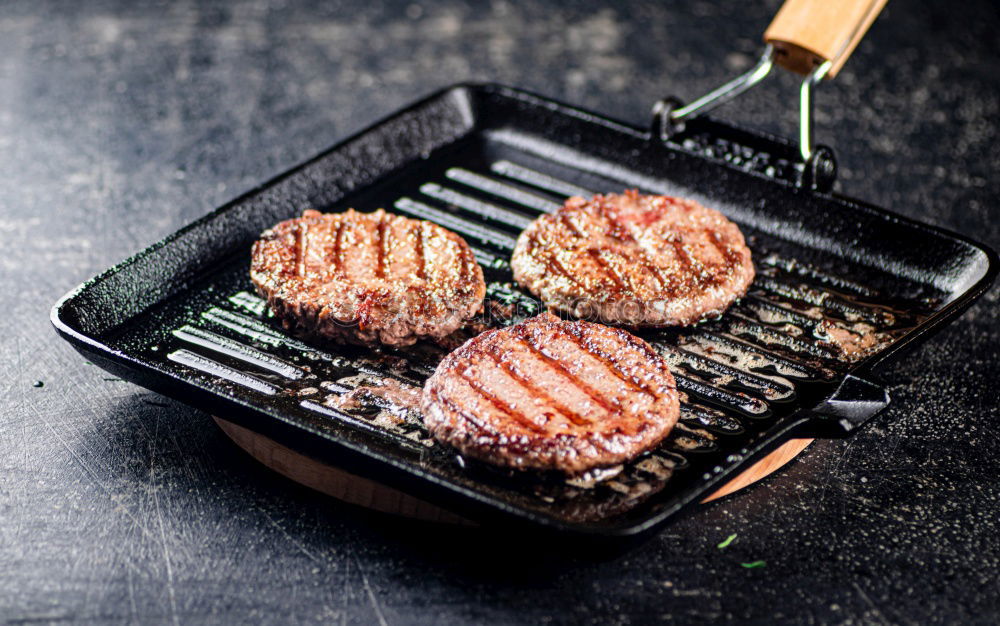 Similar – Man putting steaks into oven