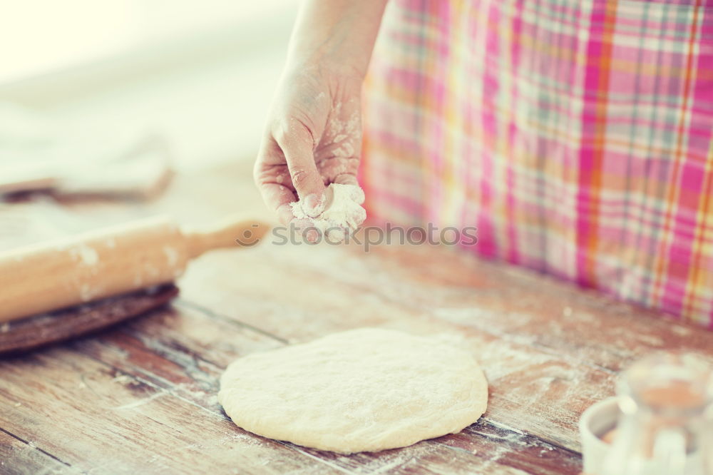 Similar – woman in bakery preparing sweets adding egg