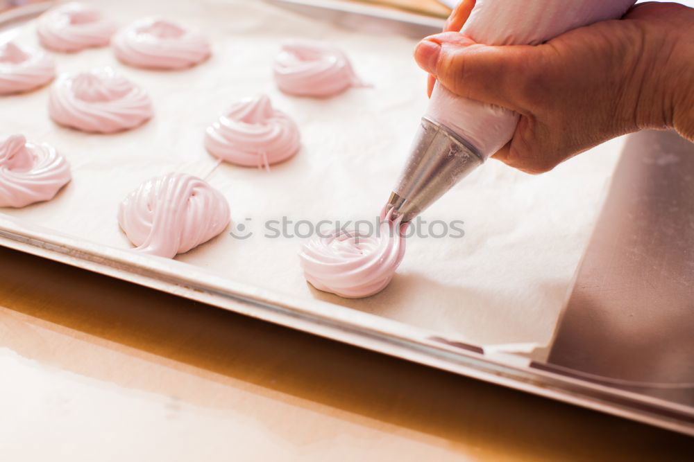 Similar – woman in bakery preparing sweets adding egg