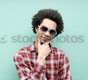 Similar – Image, Stock Photo Young beautiful Afro-American woman posing and smiling while standing against brick wall