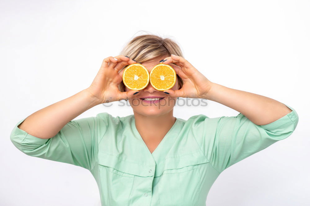 Similar – smiling little girl holding oranges over her eyes