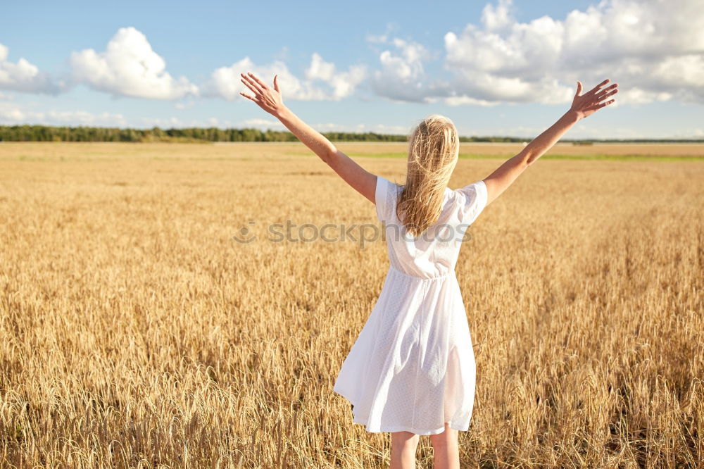 Similar – Image, Stock Photo Back view of a young woman in nature in a sunny autumn day