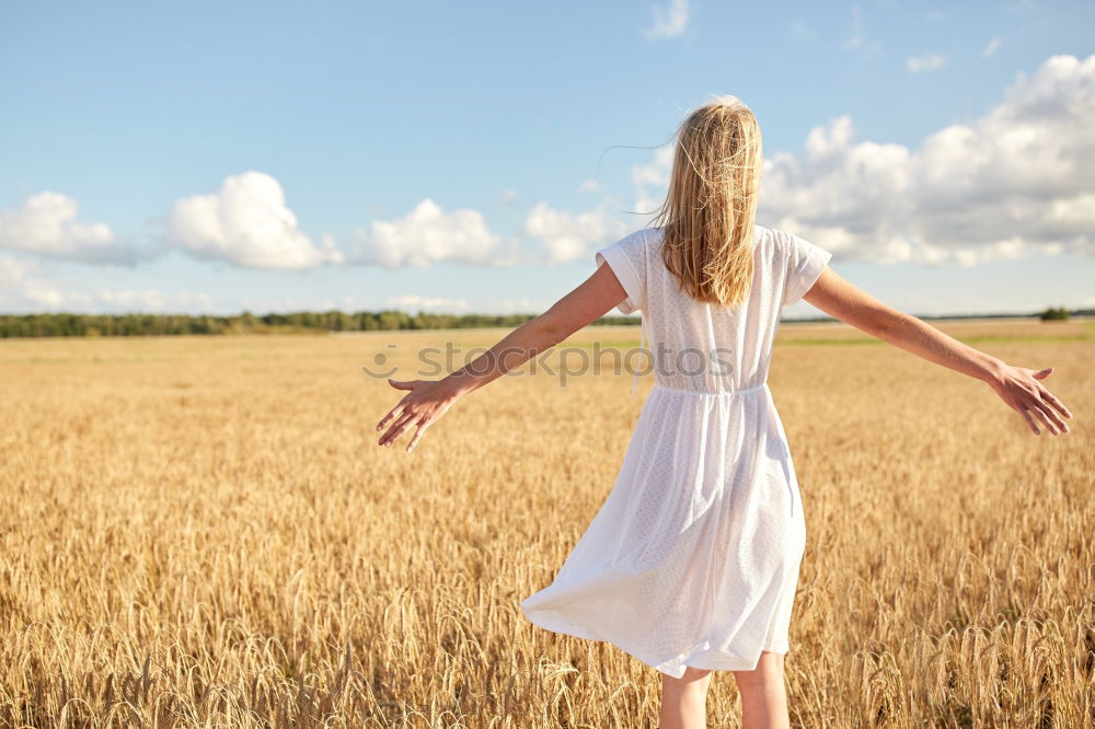 Similar – Image, Stock Photo Back view of a young woman in nature in a sunny autumn day