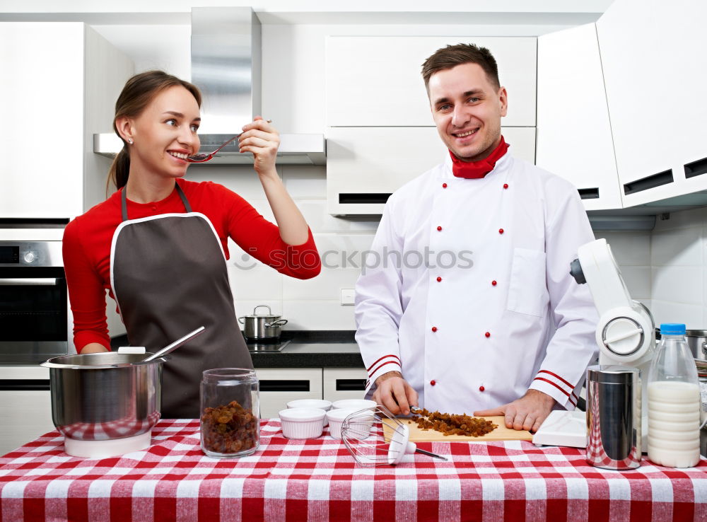 Similar – Young couple cooking. Man and woman in their kitchen