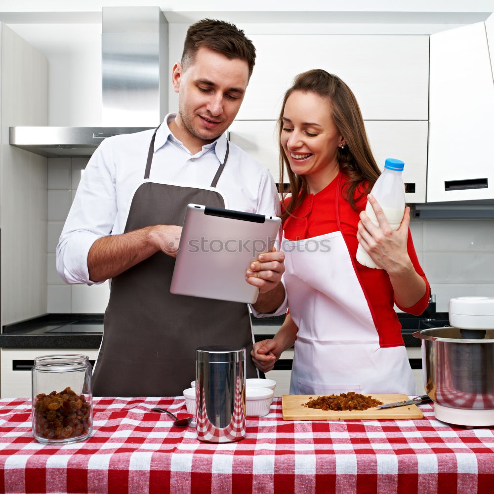 Similar – Young couple cooking. Man and woman in their kitchen