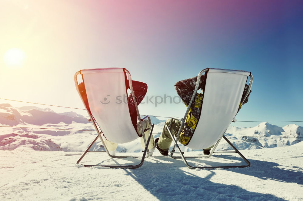 Similar – Sun loungers in the snow in front of mountain panorama