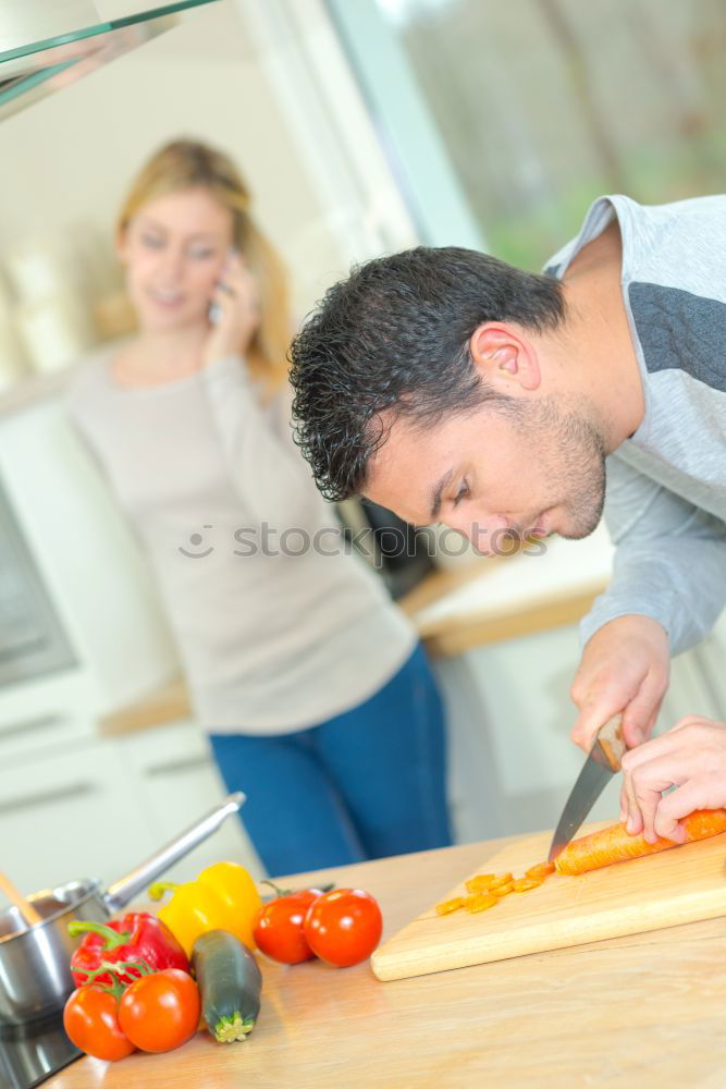 Similar – Young couple cooking. Man and woman in their kitchen