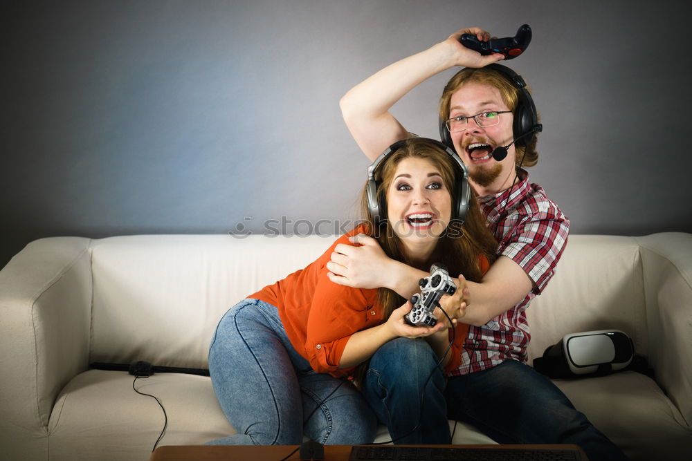 Similar – Two happy teenage girls lying on the grass sharing headphones to listen to music