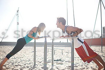 Similar – Adult fitness couple doing exercise together on beach