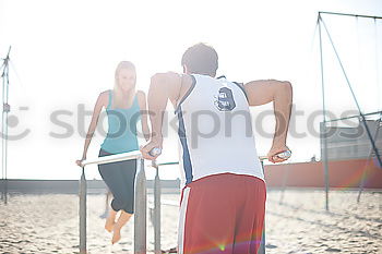 Similar – Adult fitness couple doing exercise together on beach