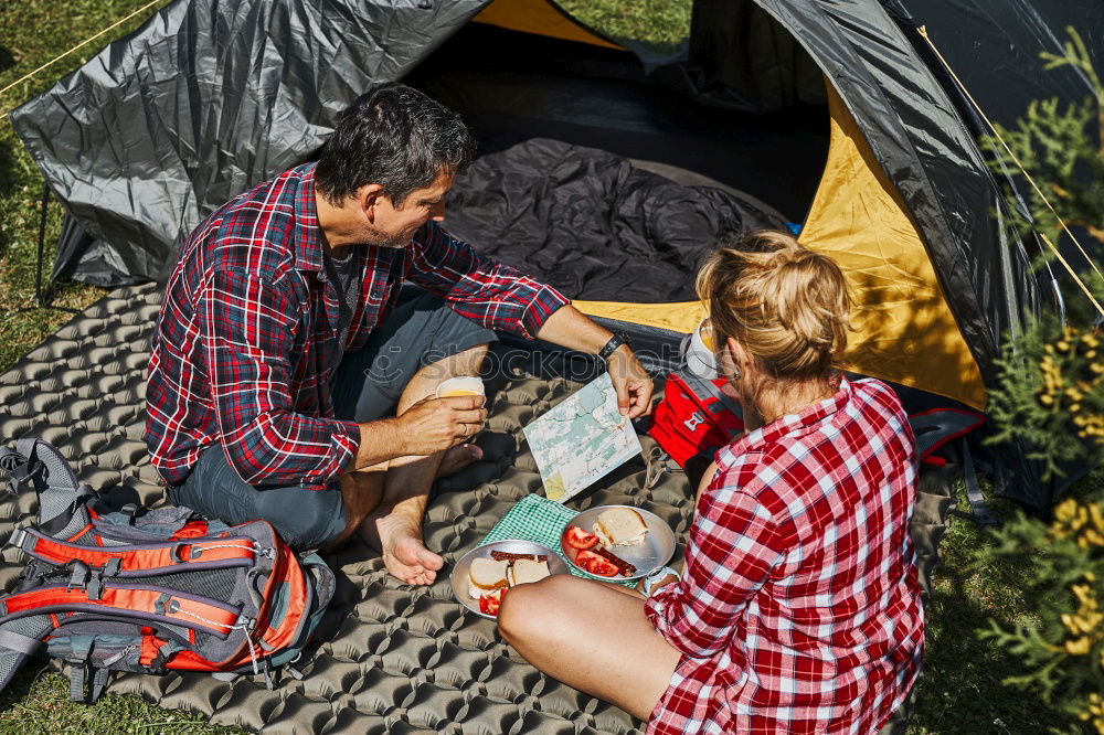 Similar – Couple planning next trip while sitting with map in tent. People relaxing in tent at camping during summer vacation