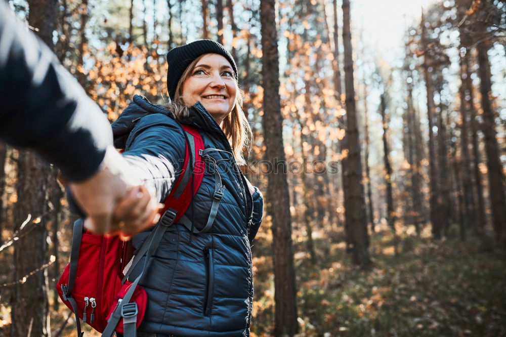 Similar – Hiker closing his partner’s backpack