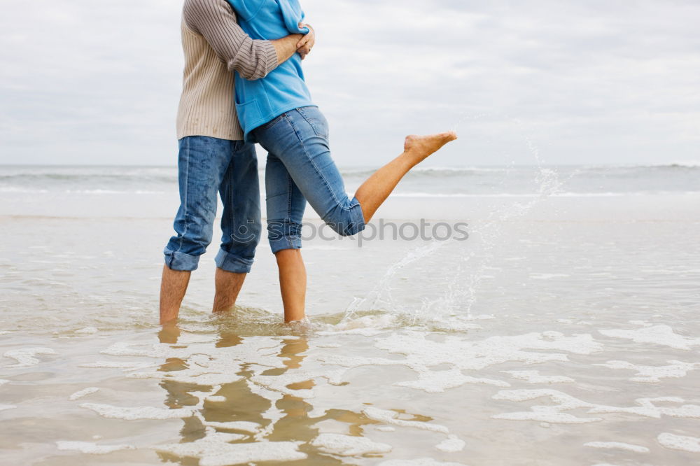 Happy father and son playing on the beach