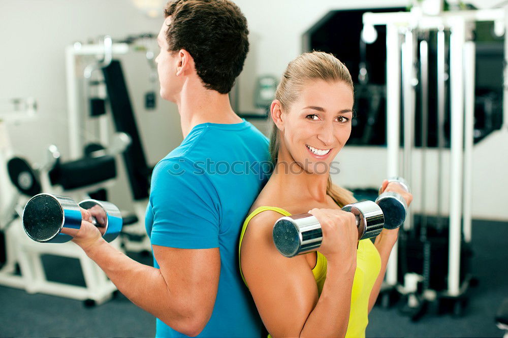 Similar – Female personal trainer helping a young man lift weights