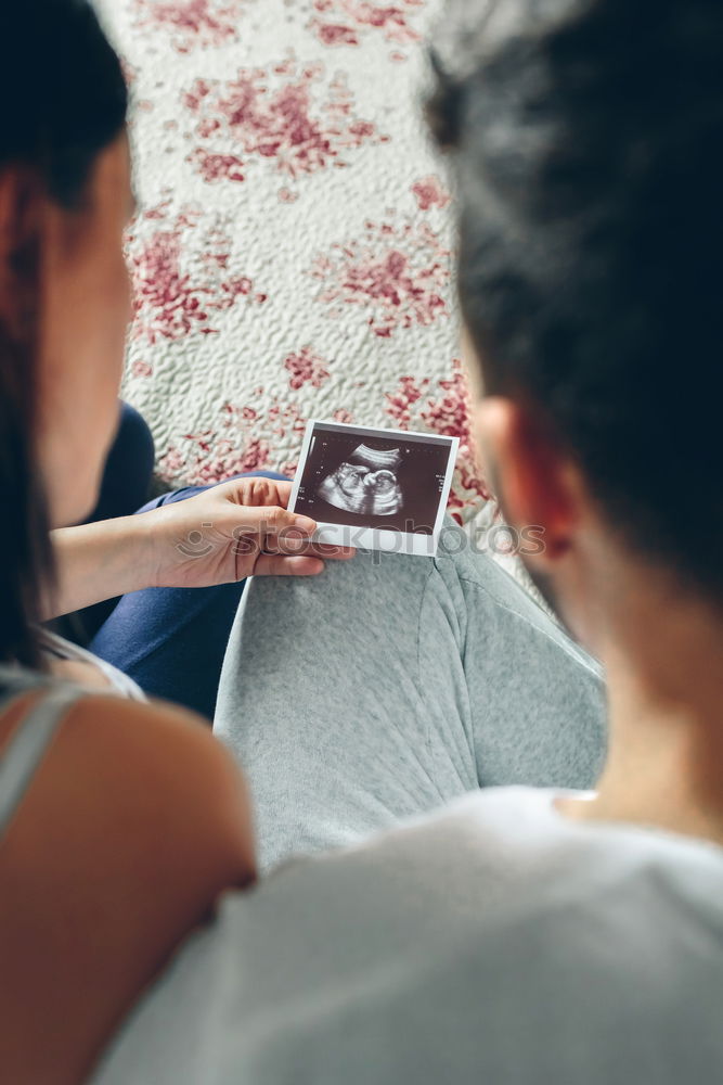 Similar – Image, Stock Photo pregnant woman sitting on the bench and loocking ultrasound scan at the day time. Concept of happy expectation.