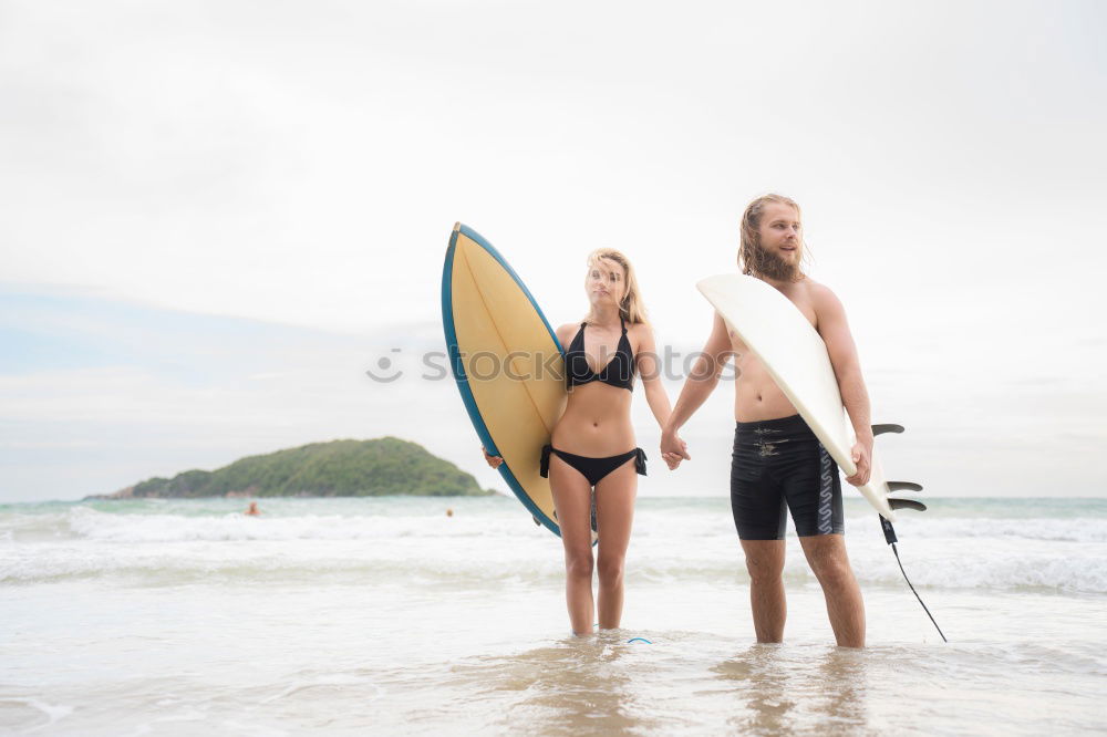 Similar – Aerial view of a surfing couple laying on the beach