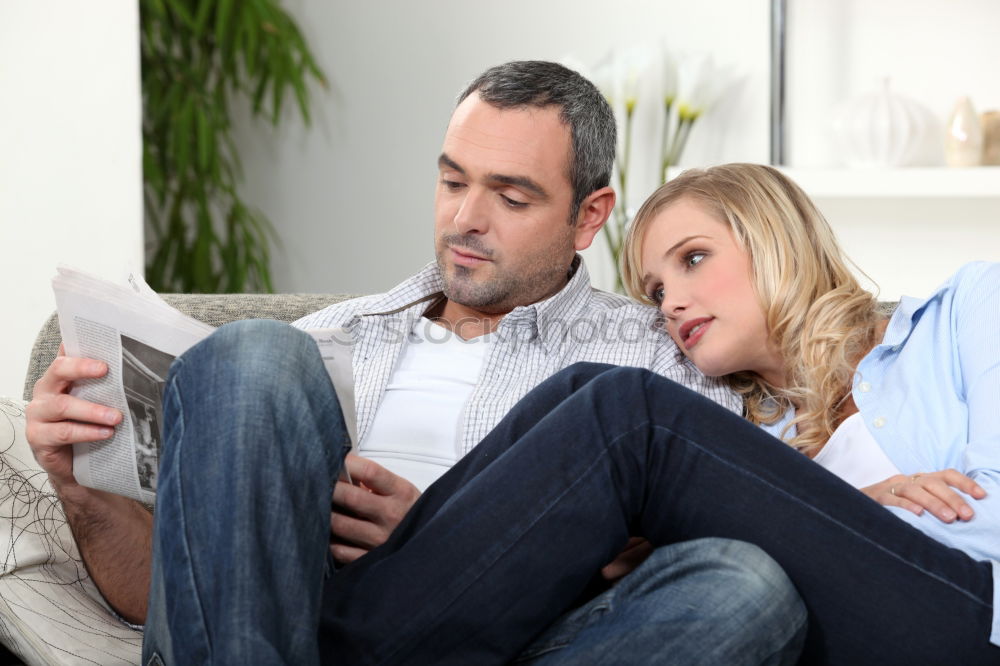 Similar – Image, Stock Photo Young couple reading book on couch at home