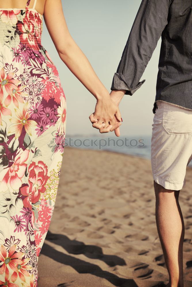 Similar – Closeup of couple holding hands