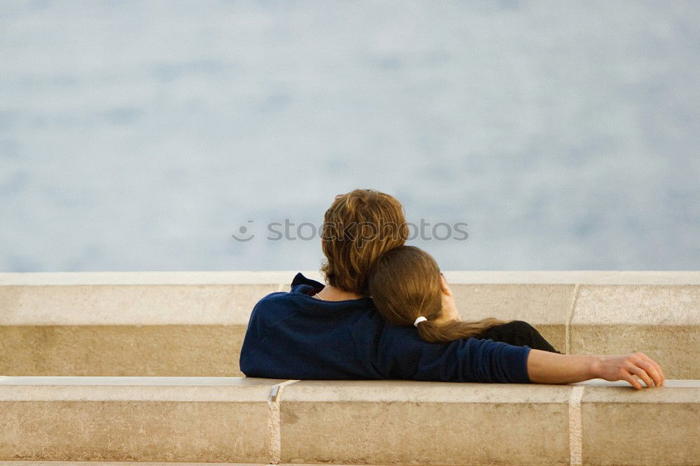 Similar – Brothers sitting at waterfront.Back view