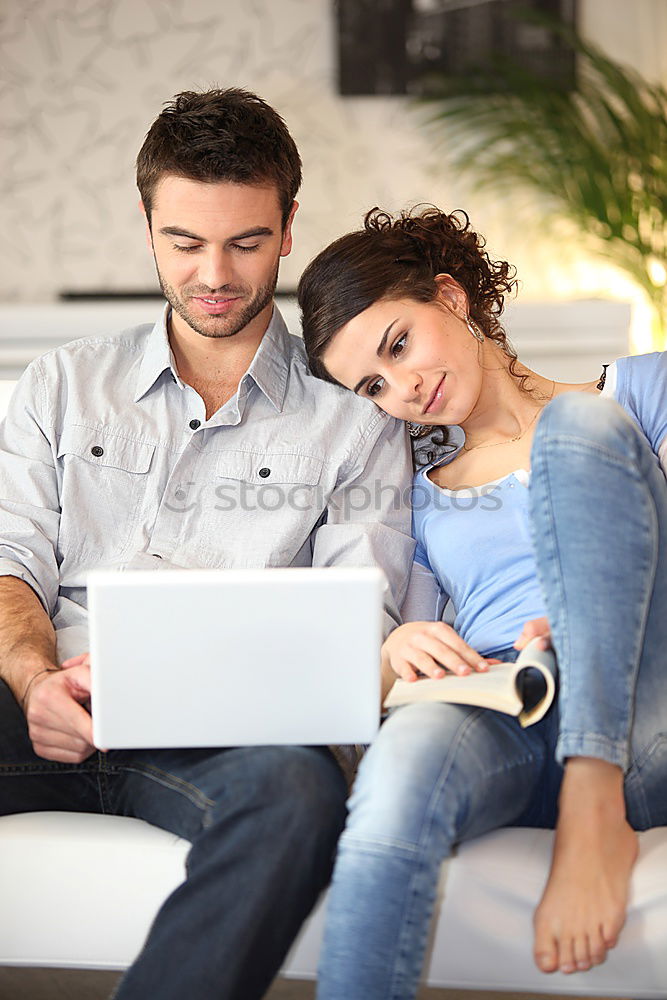 Similar – Image, Stock Photo Young couple reading book on couch at home