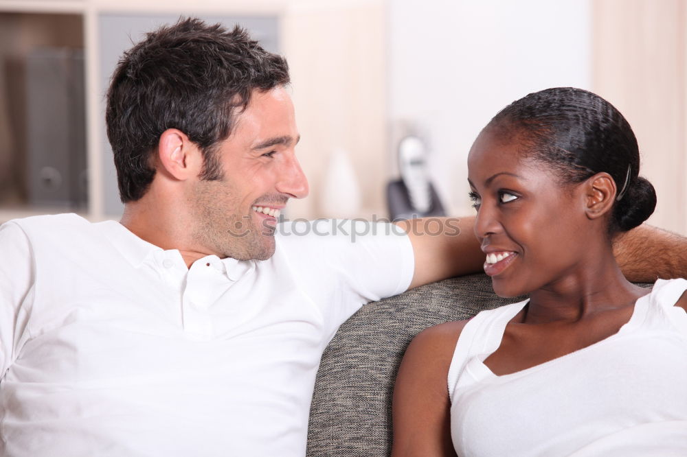 Loving Young Couple Hugging And Kissing At Home Standing In Kitchen Together