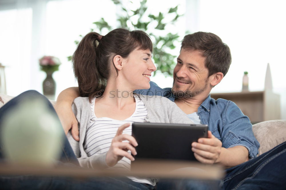 Similar – Image, Stock Photo Young couple reading book on couch at home