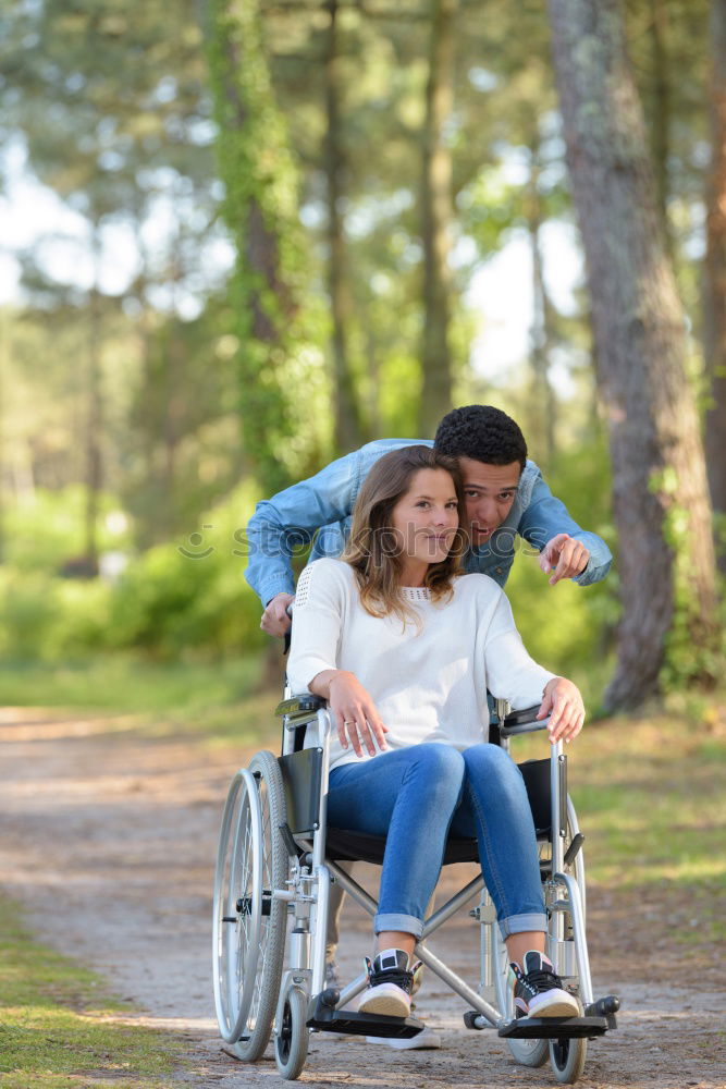 Similar – Foto Bild Frau und ihr Freund im Rollstuhl machen einen Spaziergang durch den Park an einem Fluss und genießen den Herbst