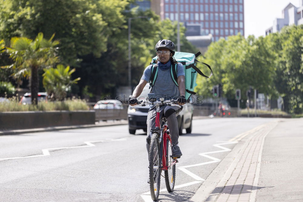 Similar – Handsome afro man walking with his bike.