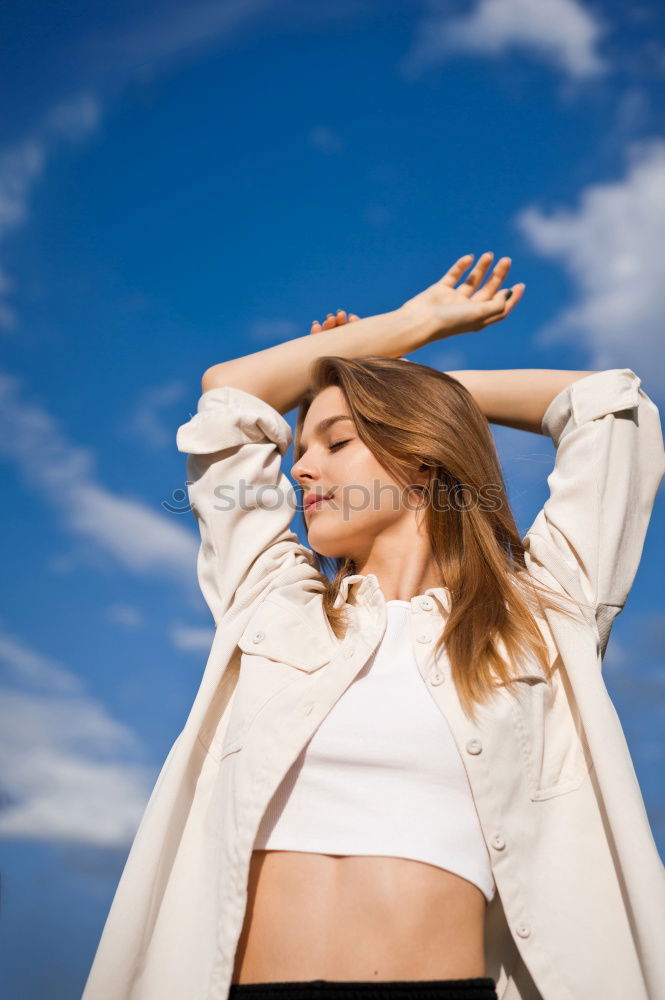 Similar – Woman barefoot sitting on roof of car