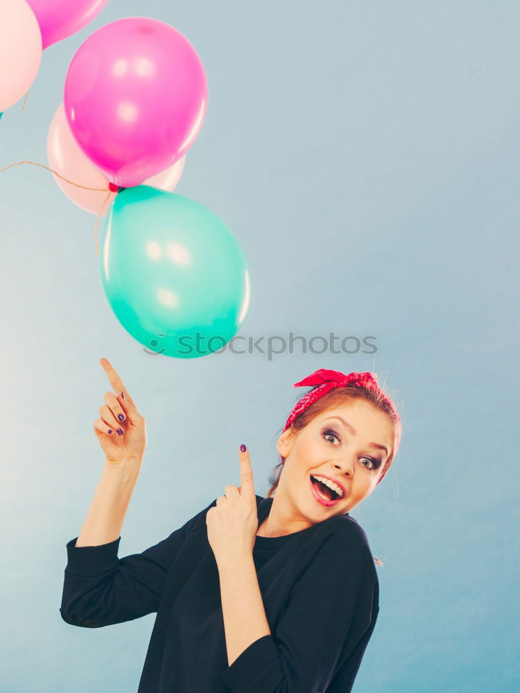 Similar – Young woman with pink hair is licking lollipops