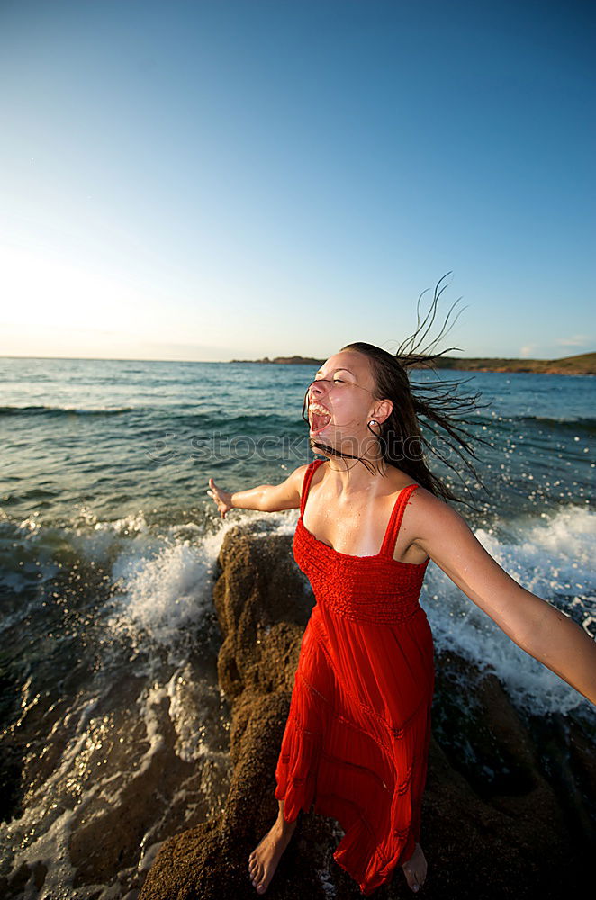 Similar – Image, Stock Photo Woman standing in the sea splashing with water in the evening light