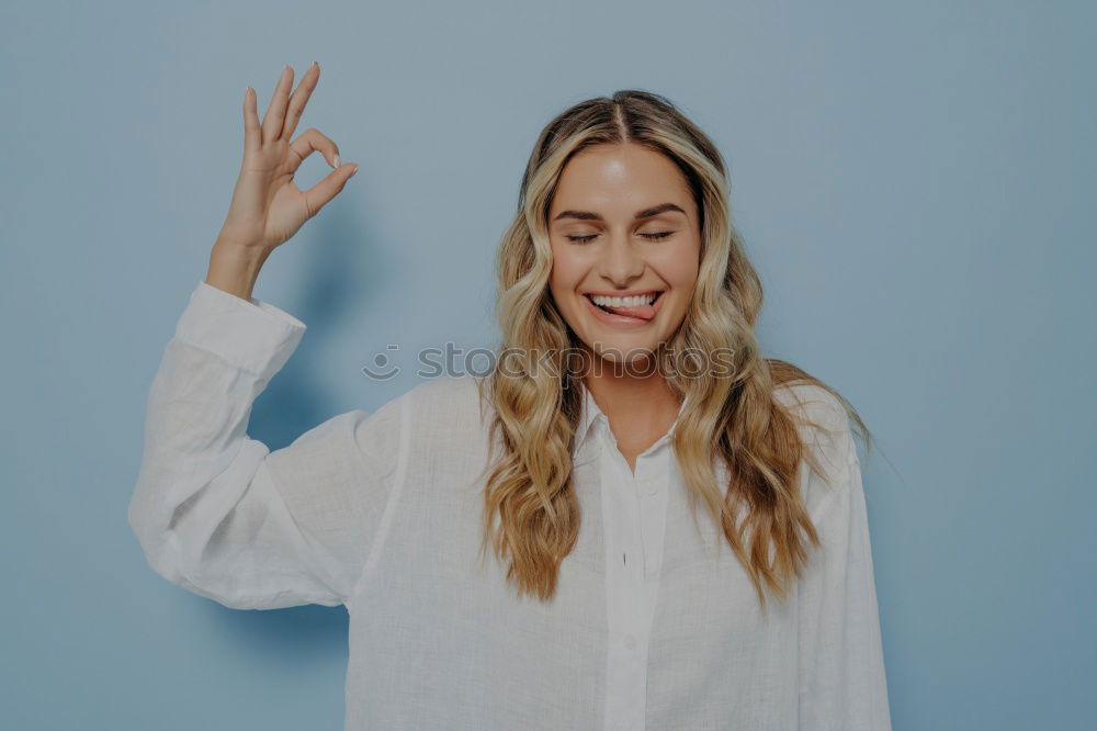 Similar – Image, Stock Photo Happy woman sitting outdoors putting her hand near the camera.