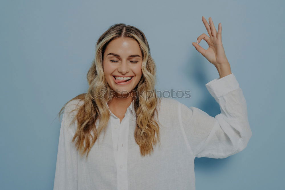 Similar – Image, Stock Photo Happy woman sitting outdoors putting her hand near the camera.