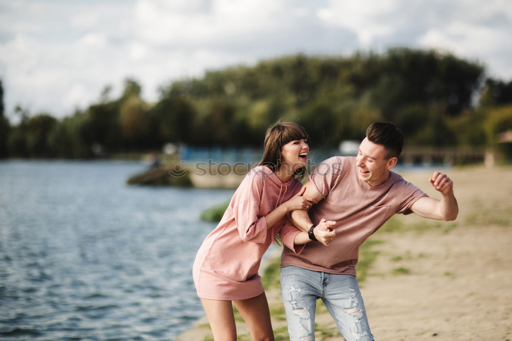 Similar – Couple lying at lake together