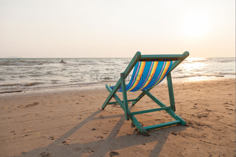 Similar – Blue and white folding chair on the beach overlooking the North Sea