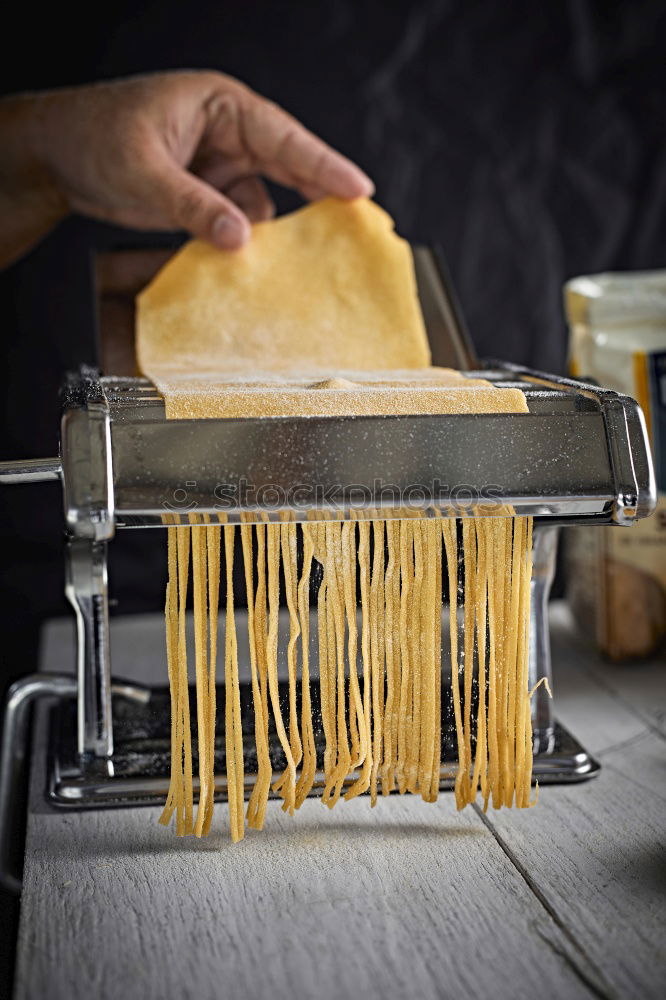 Similar – Image, Stock Photo Making homemade taglatelle with a pasta rolling cutter