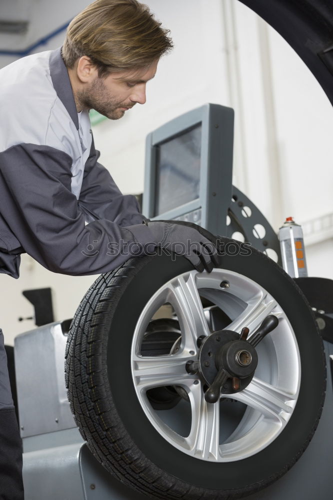 Similar – Professional Mechanic Repairing Car.