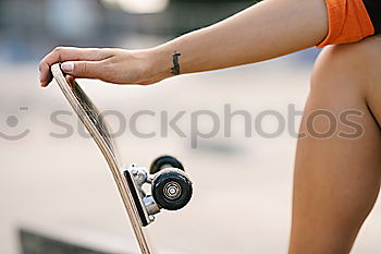 Similar – Man with tattoos holding skateboard at shore. Back view.