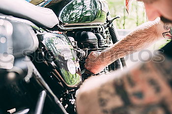 Similar – Image, Stock Photo Biker checking with a motorcycle